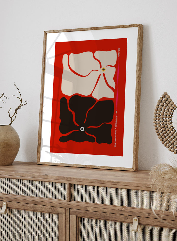 Abstract design with beige and black shapes on a red background. Two By Two Flower Red by Frances Collett is a modern abstract floral art print featuring two bold flowers in red, black, and cream tones. Officially licensed wall poster with optional framing.