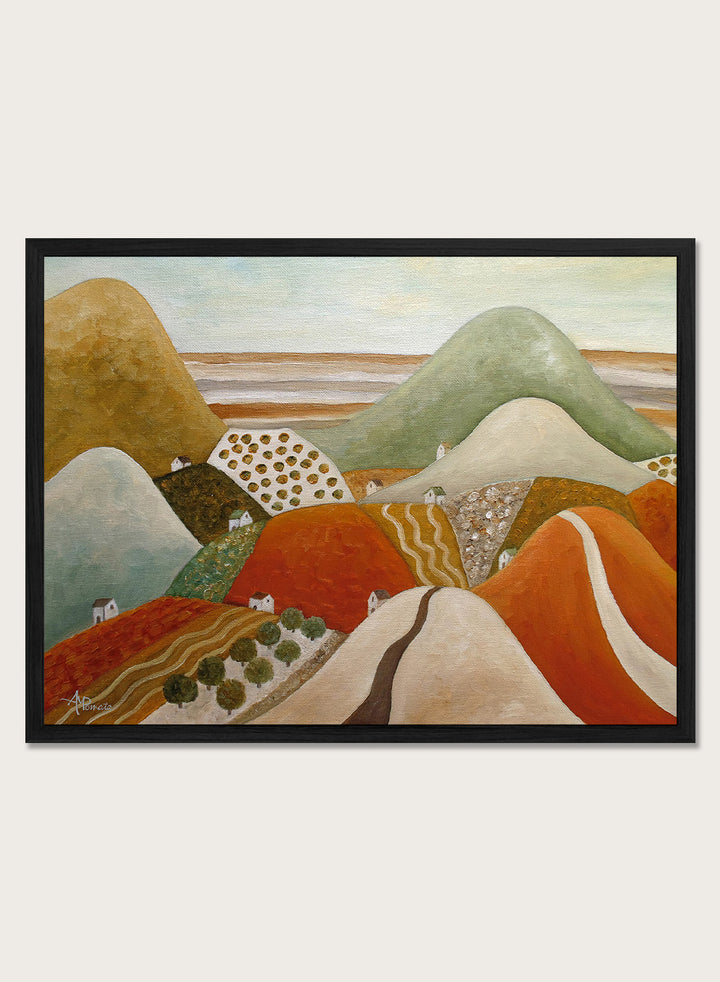 A framed landscape painting featuring stylized rolling hills and fields in earthy tones of orange, green, beige, and brown. Shop Colorful Hillside Village by Angeles M. Pomata, an autumn landscape art print featuring rolling hills, tiny homes, winding roads, and warm earthy tones.