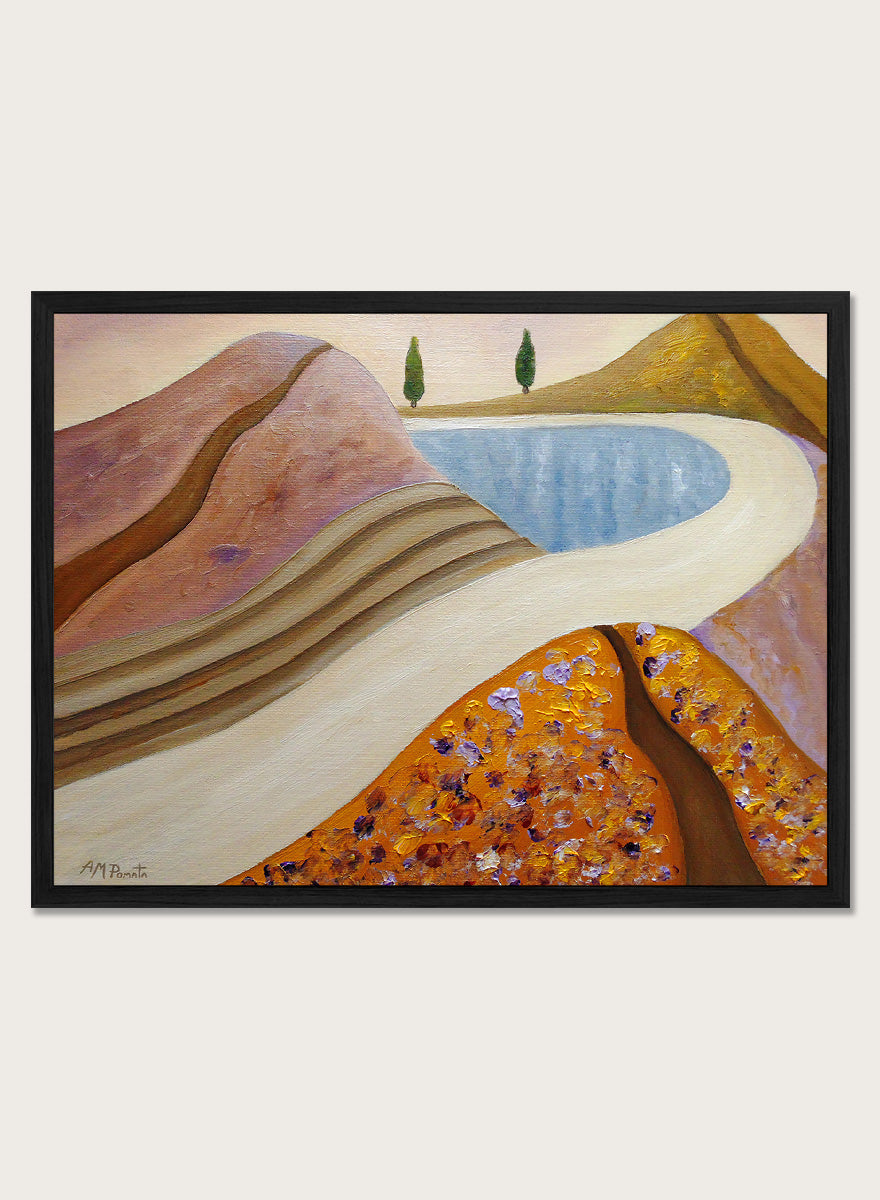 A framed landscape painting featuring stylized hills, a winding cream path, a blue pool, and two small green trees. Shop Peaceful Hills and Lake by Angeles M. Pomata, a serene landscape art print featuring a blue lake, rounded hills, winding paths, and soft earthy tones.