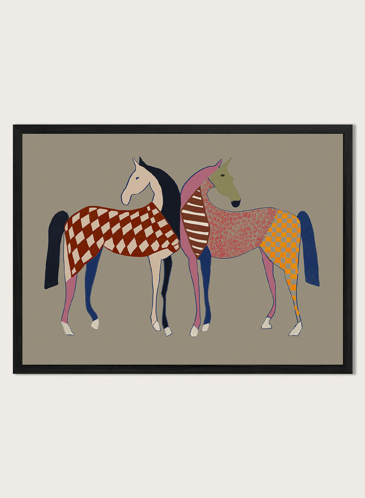 A framed art print featuring two stylized horses with colorful geometric patterns, set against a solid taupe background. Colorful Patterned Horses by The Art Concept animal art print featuring two horses with checks, stripes, florals, and bold playful color.