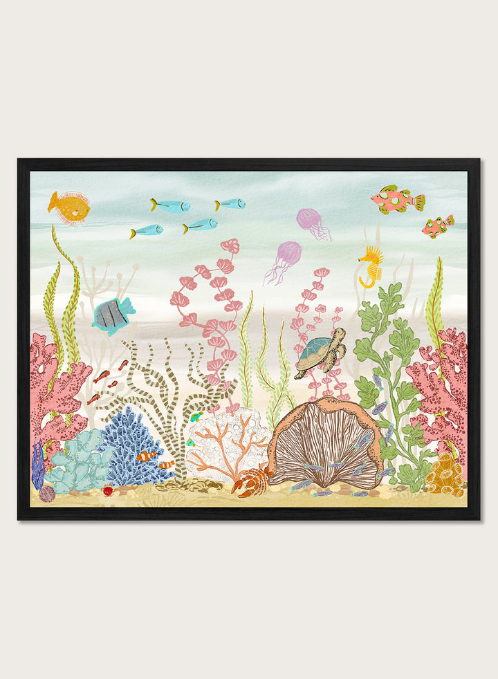 A framed art print depicting a colorful underwater scene with fish, coral, sea plants, a turtle, and a clam shell on a sandy ocean floor, shown against a light neutral background. Shop Vibrant Underwater World by Nikita Jariwala, an ocean wall art print poster with sea turtles, tropical fish, coral reef art, jellyfish, and blue tones.