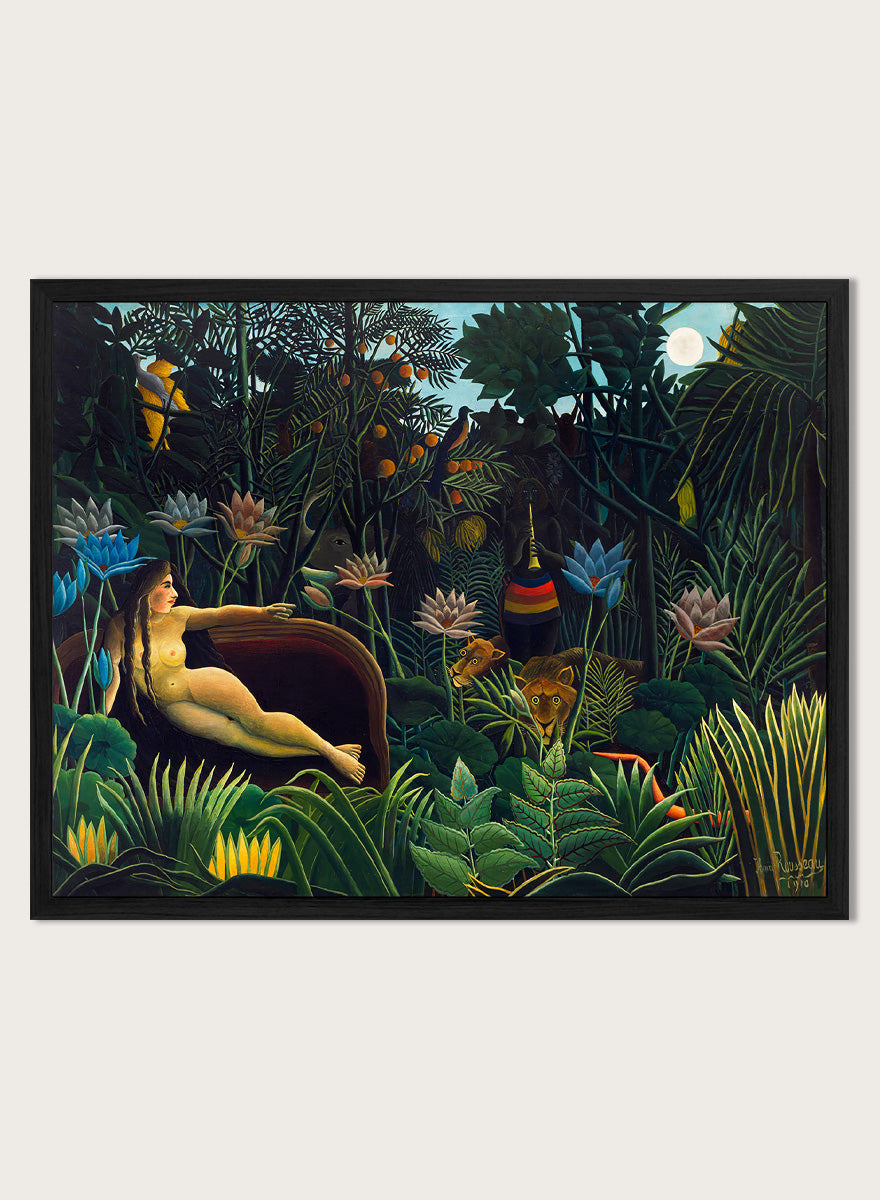 A framed art print depicting a lush, surreal jungle scene with a reclining nude woman in a boat, colorful flowers, birds, and animals under a full moon. The Dream by Henri Rousseau is a vintage jungle art print featuring a reclining woman, lush tropical plants, lions, flowers, and a moonlit forest.