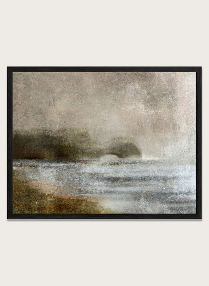 A framed abstract landscape art print featuring textured waves and a distant rocky shoreline in muted beige, gray, brown, and white tones. Shop Dusk by Dan Hobday, a moody landscape art print featuring misty water, low hills, earthy neutral toned nature, and soft layered brush texture.