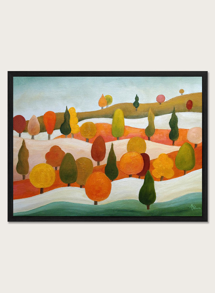 A framed landscape art print featuring stylized trees in autumn colors on rolling hills under a pale sky. Shop Colorful Autumn Hills by Angeles M. Pomata, an autumn landscape art print featuring rolling hills, stylized trees, and warm fall color.
