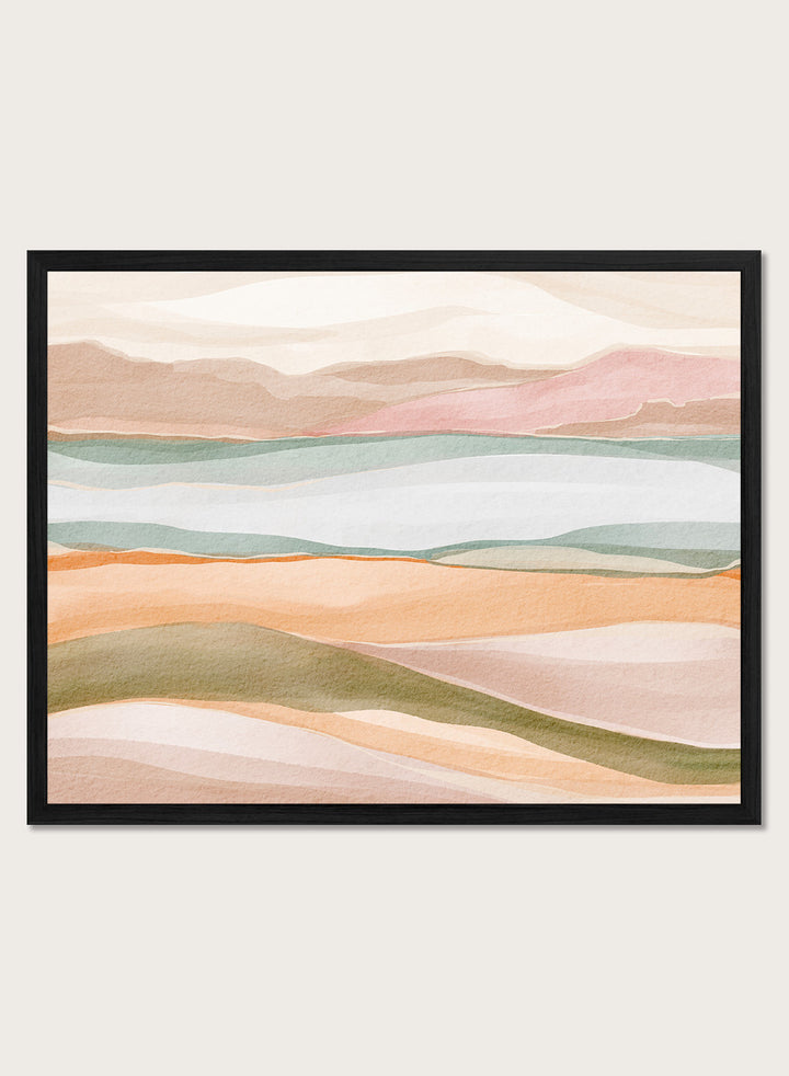 Framed abstract landscape art print featuring soft watercolor hills and layered fields in pastel peach, pink, sage green, cream, and light blue. Shop Calm Watercolor Landscape by Nikita Jariwala, an abstract landscape wall art print poster with rolling hills, mountain scenery, watercolor layers, and soft green tones.
