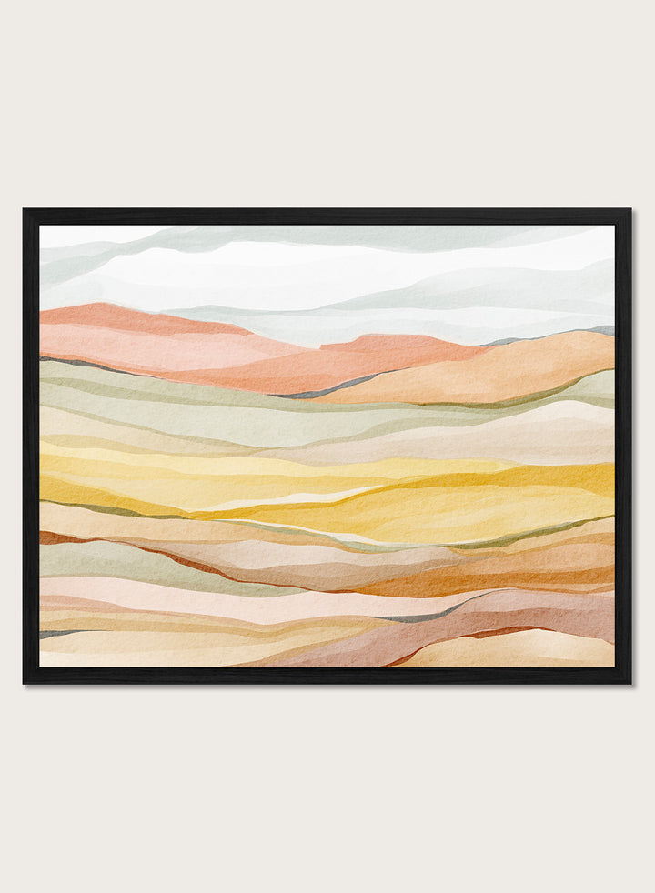 Framed abstract landscape wall art featuring layered wavy hills in soft peach, yellow, beige, and muted green tones. Shop Warm Horizon Layers by Nikita Jariwala, an abstract landscape wall art print poster with layered hills and mountains, soft yellow fields, and warm peach tones.