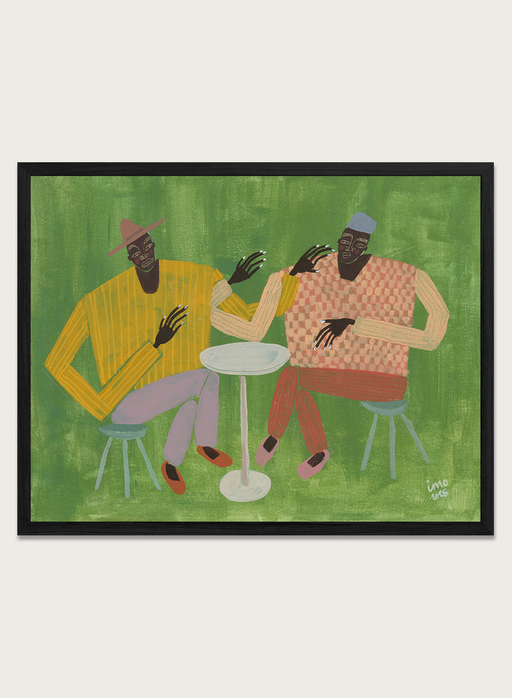 Framed artwork of two people sitting at a table on a green background. In Good Company by Studio IMO (Ibi Meier-Oruitemeka) is a modern figurative art print featuring two figures at a table in a bold contemporary wall poster design.