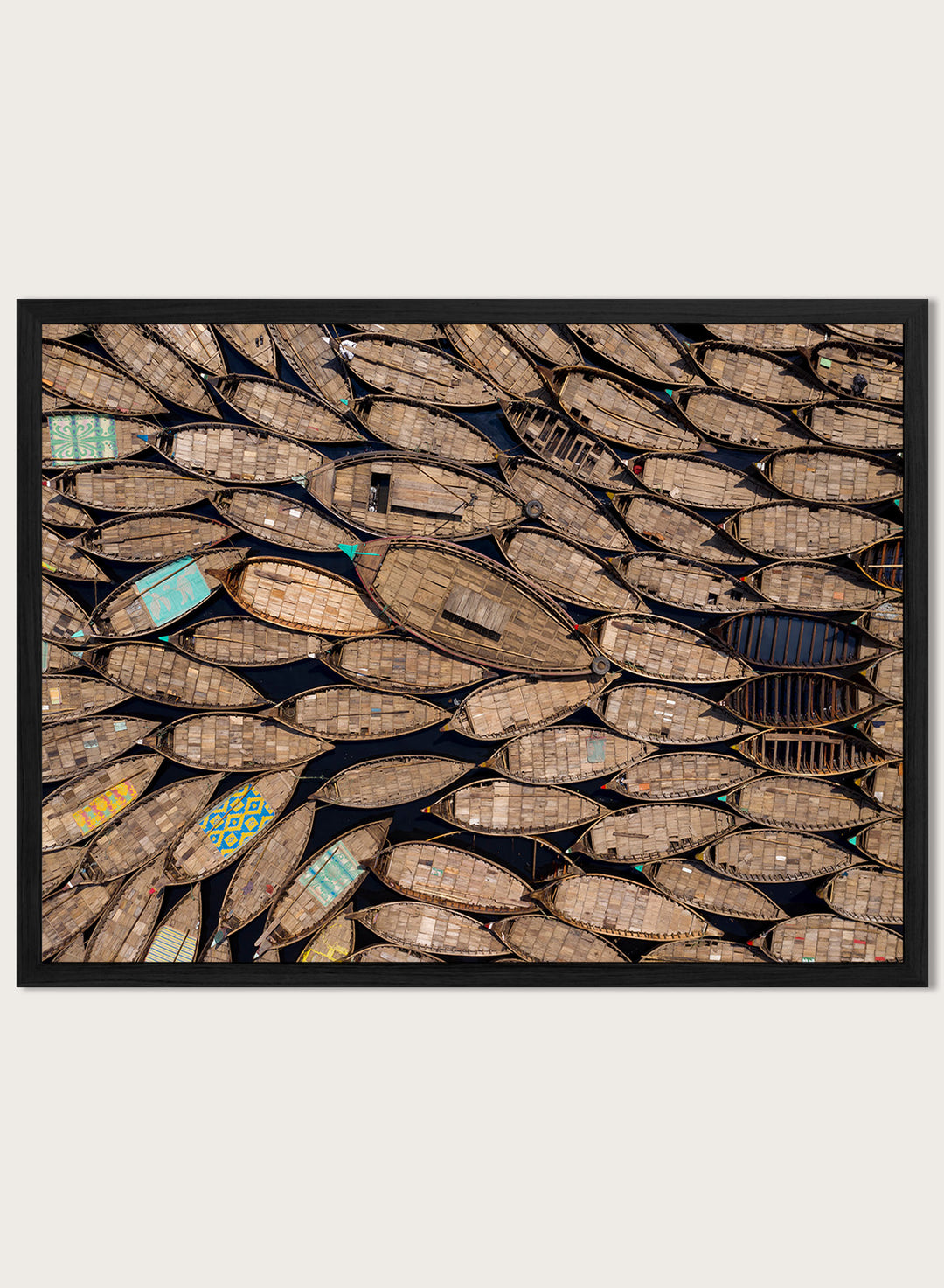 Framed artwork of a pattern made from wooden boats. Wooden Boats by Azim Khan Ronnie aerial photography print showing clustered wooden boats from above, textured pattern wall art poster