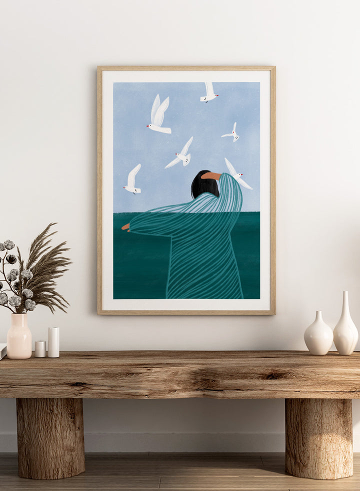 Seaside Serenity by Bea Müller is an officially licensed art print featuring a calm seaside figure and flying birds. Available as fine art print or framed with real wood frames.