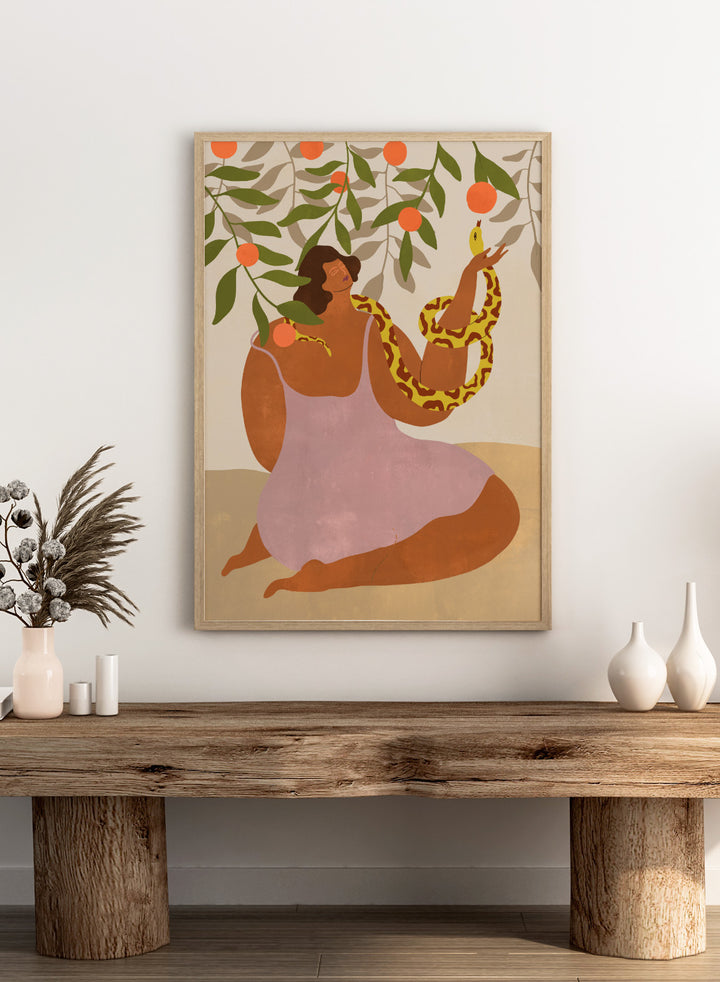 Illustration of a woman holding a snake with oranges and leaves in the background. Eden’s Embrace by Arty Guava art print featuring woman with snake under orange tree branches, tropical nature illustration, and vibrant contemporary wall art poster.