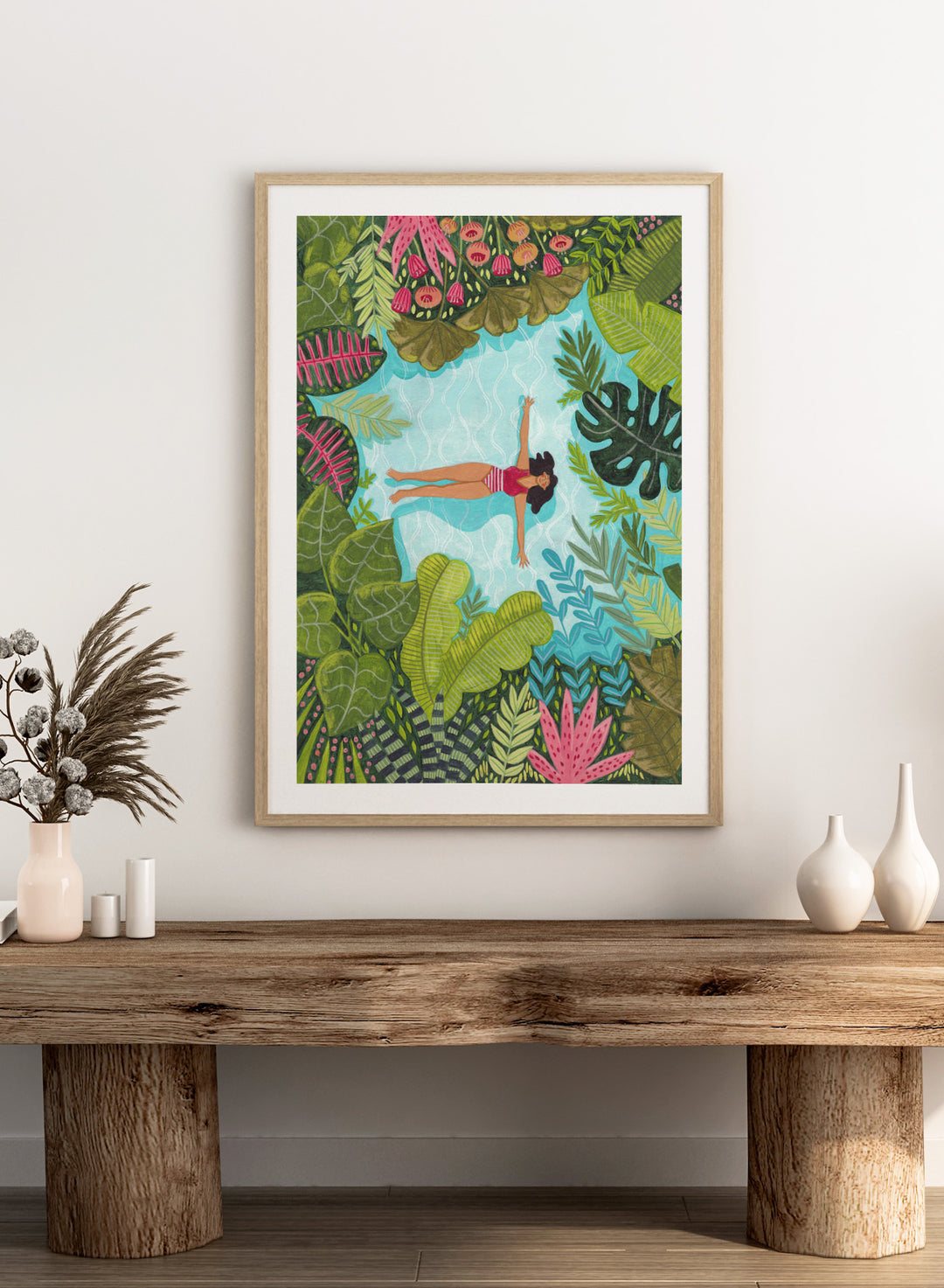 Illustration of a woman swimming in a pool surrounded by tropical plants. Tropical Pool Relaxation by Caroline Bonne Müller is a fine art print and wall poster of a woman floating in a pool surrounded by tropical plants.