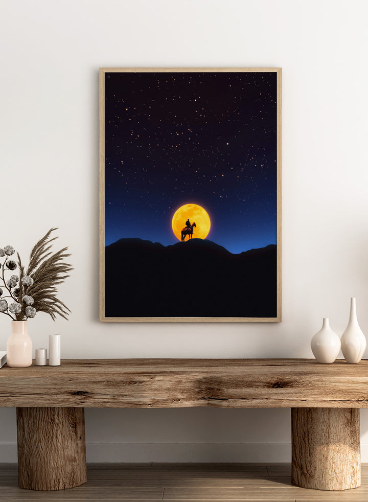 Silhouette of a person on horseback under a large orange moon and starry night sky. The Rider and the Moon by Taudalpoi cowboy moon art print with horse silhouette, starry sky and glowing full moon retro cosmic poster wall art.