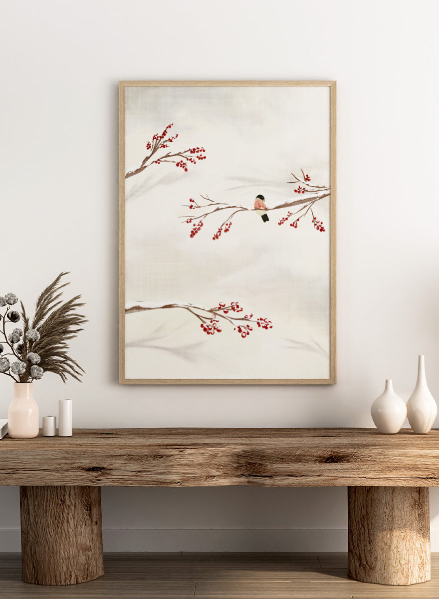 Shop Winter Bird With Berries by Nikita Jariwala, a winter bird wall art poster print featuring snowy branches, red berries, soft neutrals, and delicate seasonal detail.