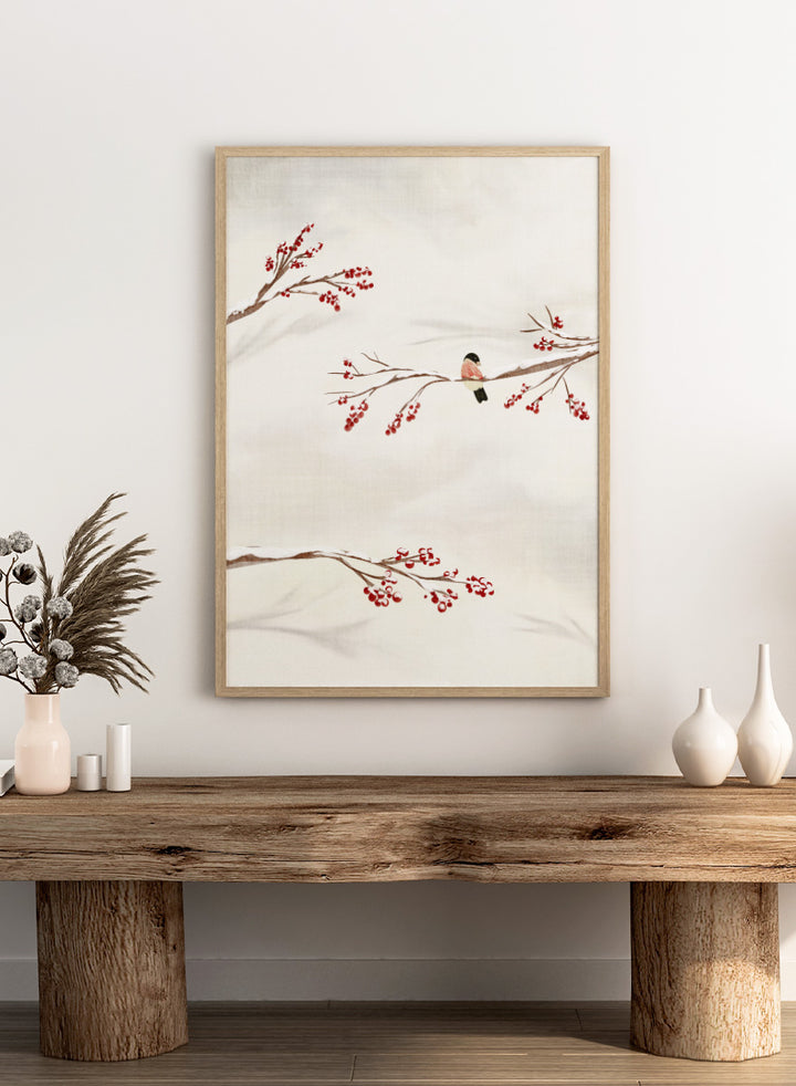Shop Winter Bird With Berries by Nikita Jariwala, a winter bird wall art poster print featuring snowy branches, red berries, soft neutrals, and delicate seasonal detail.