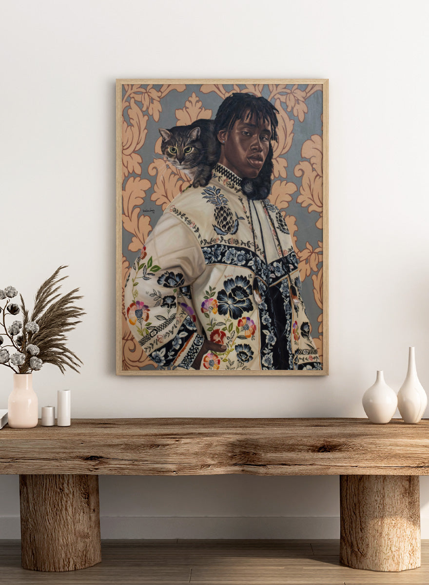 A stylized portrait painting of a Black man wearing an ornate cream jacket with colorful floral embroidery, seated against a patterned wallpaper background with a gray tabby cat on his shoulder. Shop Man and Cat Portrait by Damilare Jamiu, a contemporary figurative wall art print featuring a man with a cat, embroidered clothing, and rich floral detail.
