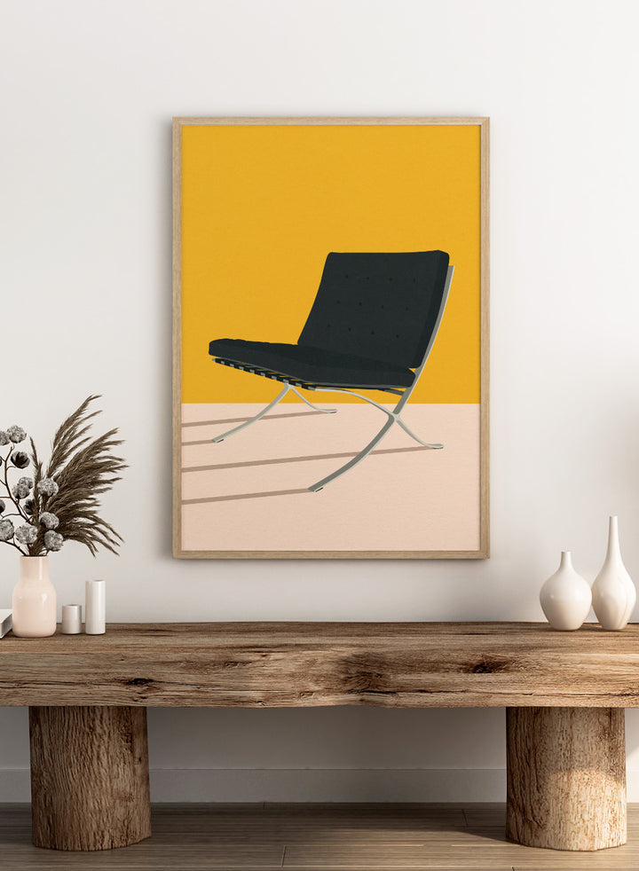 Black chair with metal legs on a yellow and beige background. Barcelona Chair by Mies Van Der Rohe by Rosi Feist is a minimalist modern design art print featuring clean lines and bold color. Officially licensed fine art poster with optional real wood framing, ready to hang.