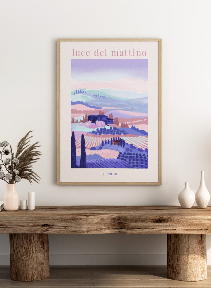 Artistic depiction of a Tuscan landscape with rolling hills and a farmhouse, labeled 'luce del mattino toscana'. Tuscany Morning by Goed Blauw is a landscape art print and wall poster featuring rolling hills, fields, and houses in soft pastel tones inspired by the Italian countryside.