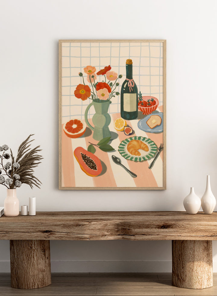 A stylized still life illustration showing a bottle, flowers in a pitcher, fruit, bread, and tableware on a striped surface against a grid background. Colorful Breakfast Still Life by Katarzyna Gąsiorowska art print featuring fruit, flowers, a croissant, and colorful kitchen tableware in soft modern tones.