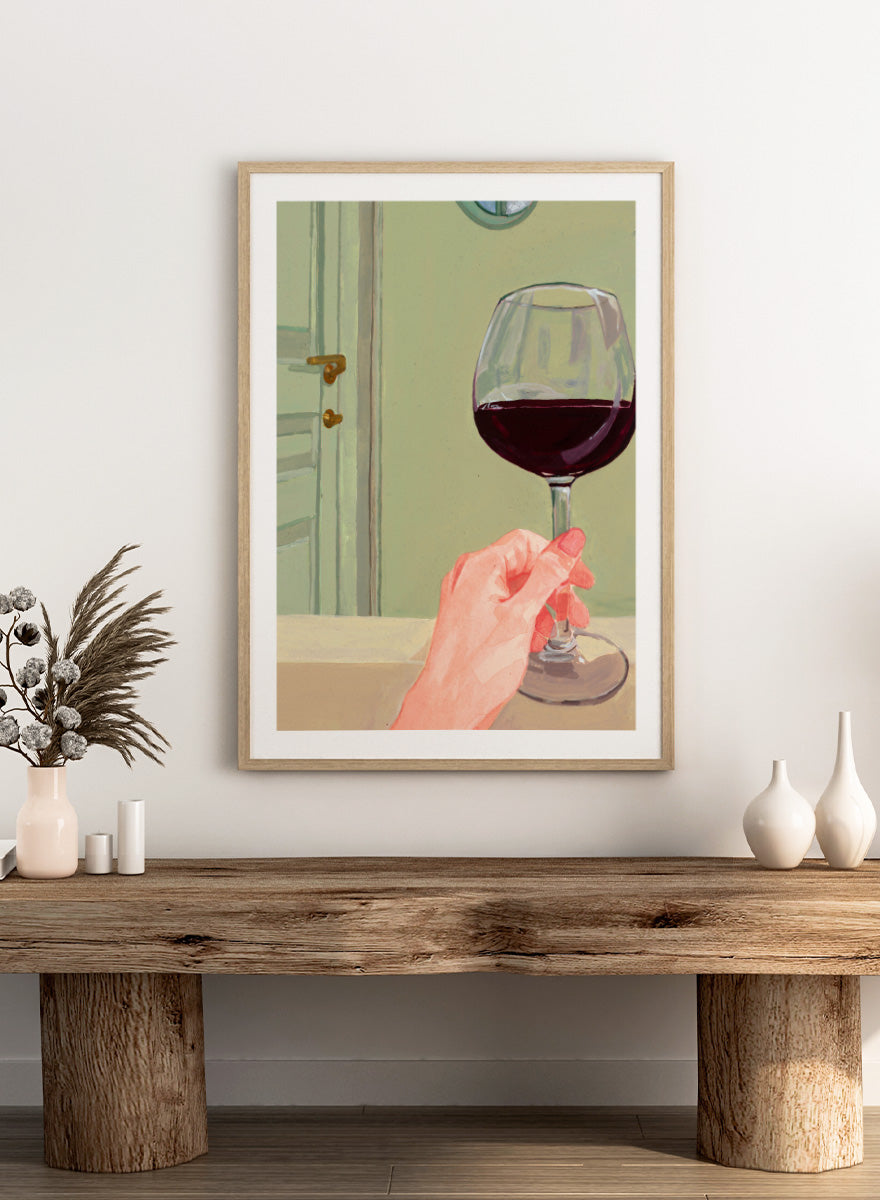 Shop Relaxing Wine Moment by Sophia Novosel, a modern wall art print poster featuring a hand holding red wine in a soft green interior with warm tones.
