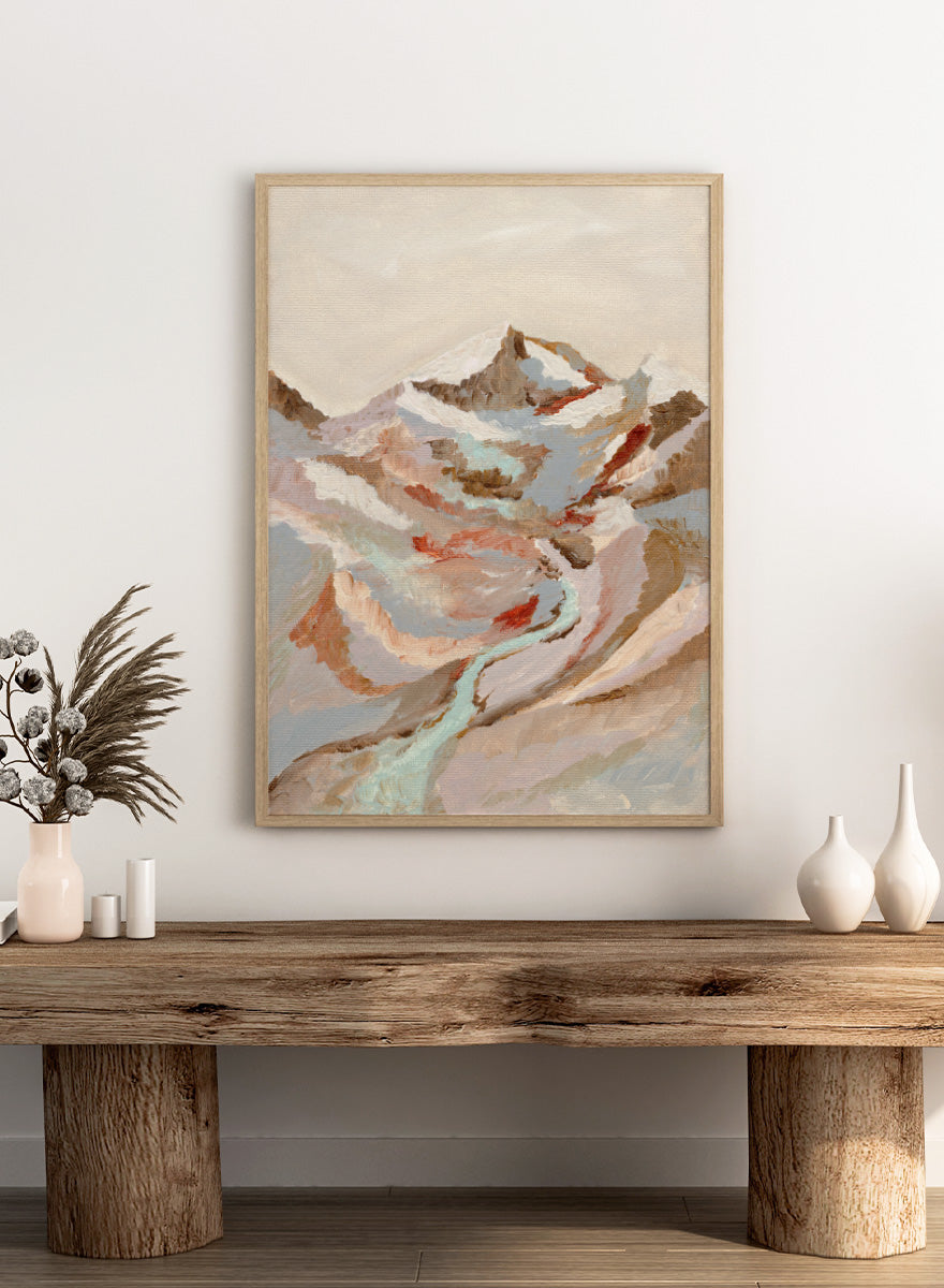 An abstract landscape painting of a snow-capped mountain range with a winding pale blue river, rendered in textured brushstrokes of beige, brown, gray, and muted red tones. Shop Painted Mountain River by Nikita Jariwala, a mountain landscape wall art print poster featuring a winding river, snowy peaks, and soft blue tones.