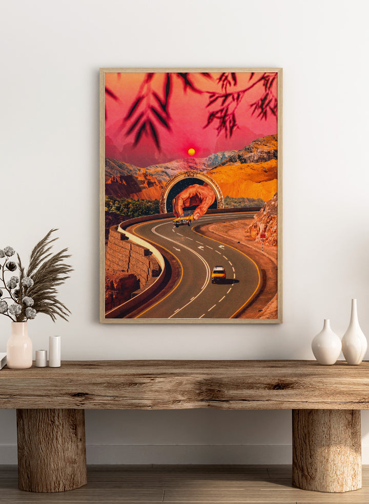 Winding road with a large hand-like structure in a desert landscape during sunset. Play Time by Taudalpoi surreal retro road trip art print with giant hand, desert highway and vintage car collage, cosmic inspired poster wall art.