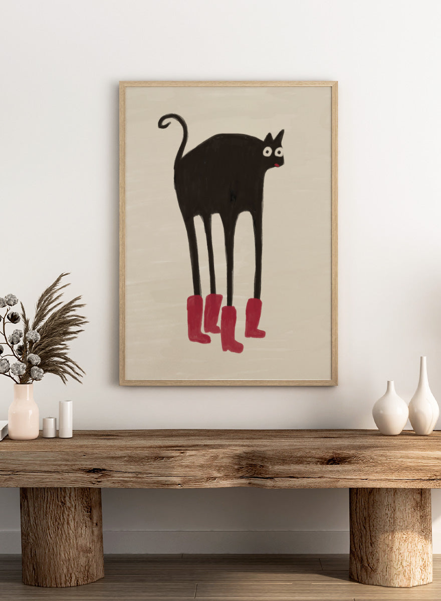 A stylized black cat with long legs wearing bright pink boots, centered on a warm beige background. Funny Black Cat Boots by The Art Concept playful cat art print featuring a long-legged black cat in red boots with a quirky hand-drawn look.