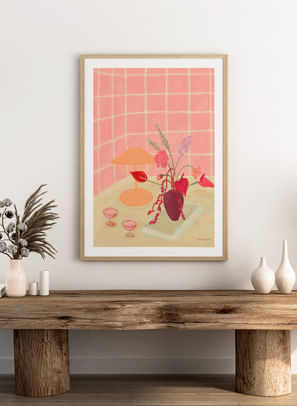 Illustration of a table with a vase of flowers, two glasses, and an orange lamp against a pink tiled wall. Bubbly by Katharina Puritscher art print featuring pink tiled walls, floral still life, coupe glasses, and a cozy tabletop scene. Officially licensed wall poster.