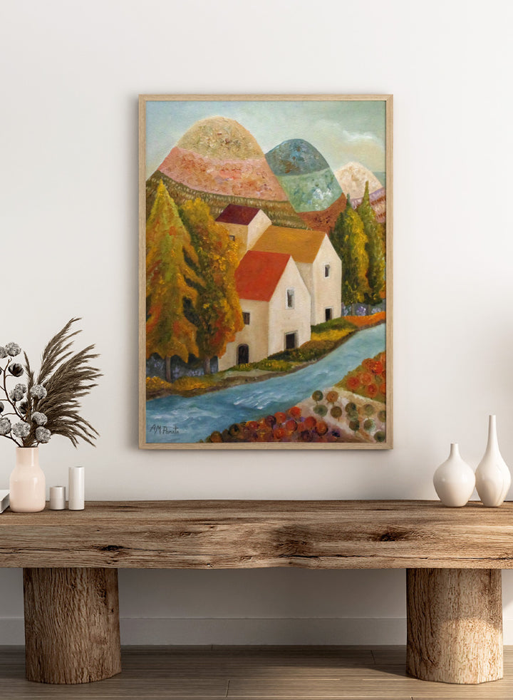 Shop Autumn Village River by Angeles M. Pomata, an autumn landscape art print featuring a blue river, white village houses, colorful trees, and rolling hills.