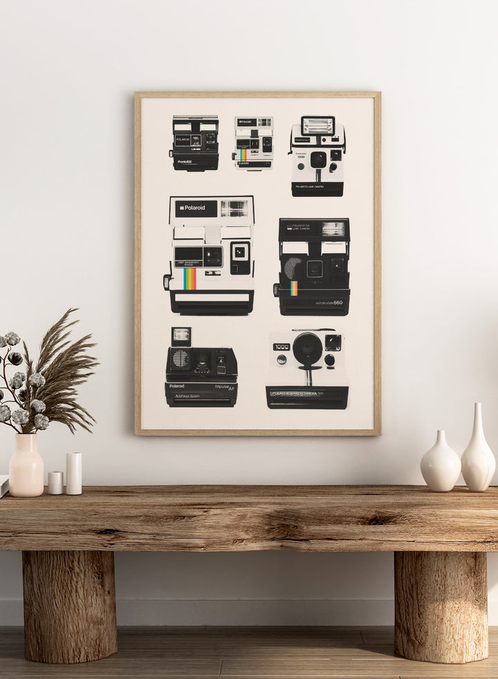 Collection of Polaroid cameras displayed against a white background. Vintage Instant Cameras by Florent Bodart is a retro camera art print featuring classic Polaroid designs, a modern wall poster for photography and design lovers.