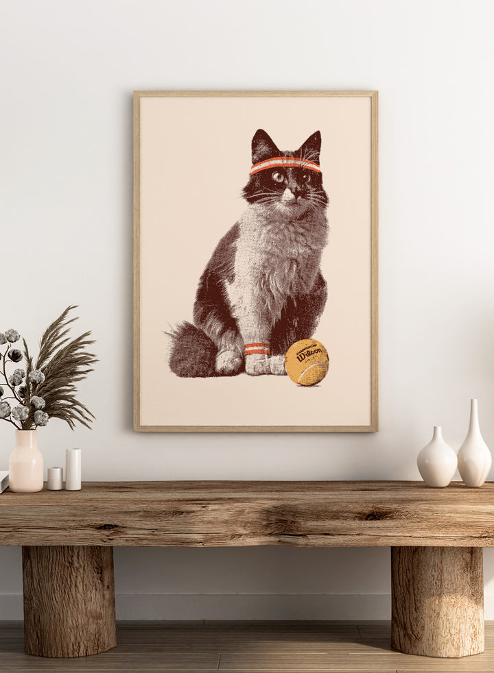 Cat wearing a striped bandana with a tennis ball on a beige background. Retro Tennis Cat by Florent Bodart is a playful cat art print with vintage tennis style, a modern wall poster with retro texture, humor, and character.
