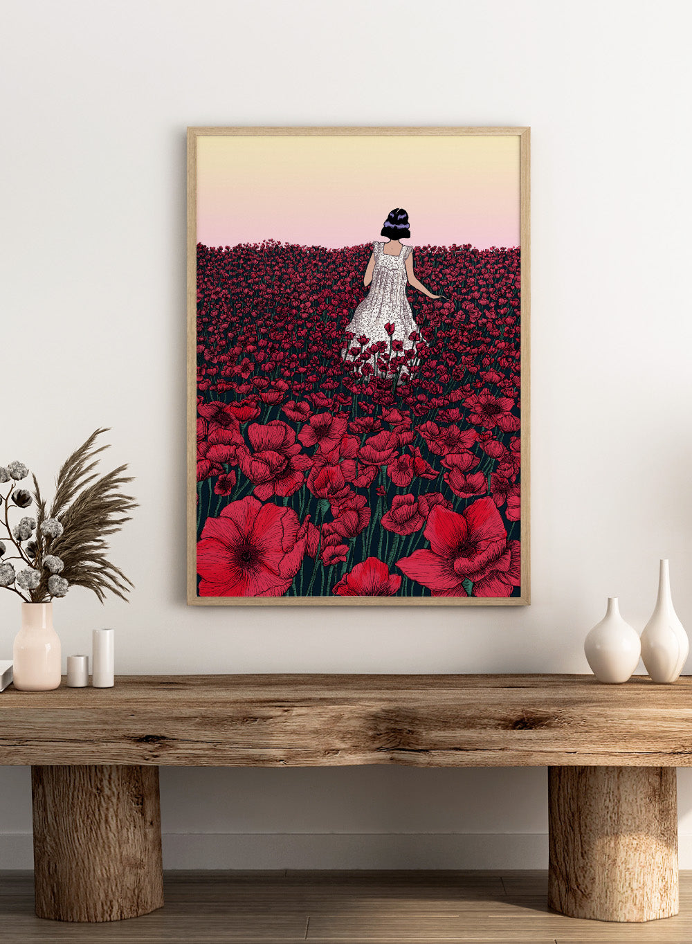 Woman in a white dress standing in a field of red flowers with a gradient sky. Field of Poppies by E.C. Mazur is an officially licensed art print featuring a woman standing in a red poppy field. Illustrated landscape wall poster.