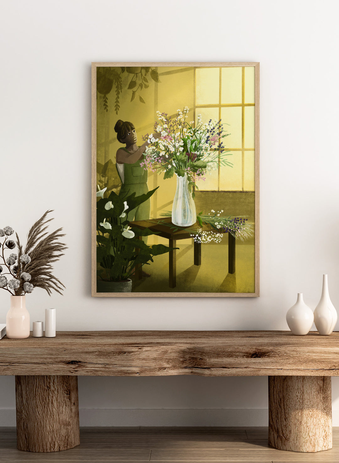 Woman in a green dress holding a bouquet of flowers in a softly lit room. In the Cracks of Light I Dream by Goed Blauw is a floral art print and wall poster featuring a woman arranging flowers in warm window light.
