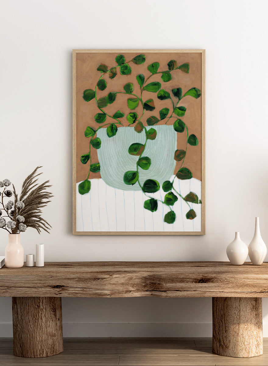 Shop Warm Houseplant Pot by Nikita Jariwala, a botanical wall art print poster featuring a trailing houseplant in a green pot with warm green tones.