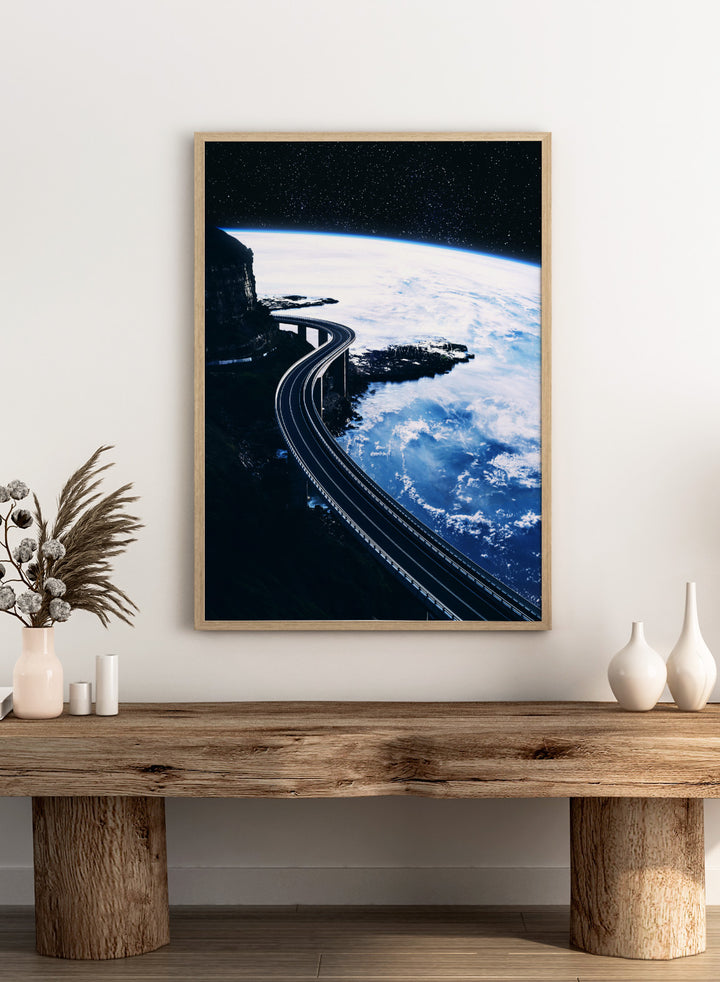 Artistic depiction of a road curving around the Earth with a starry night sky. Road To Infinity by Taudalpoi surreal space highway art print with winding road above Earth and starry sky, retro cosmic collage poster wall art.