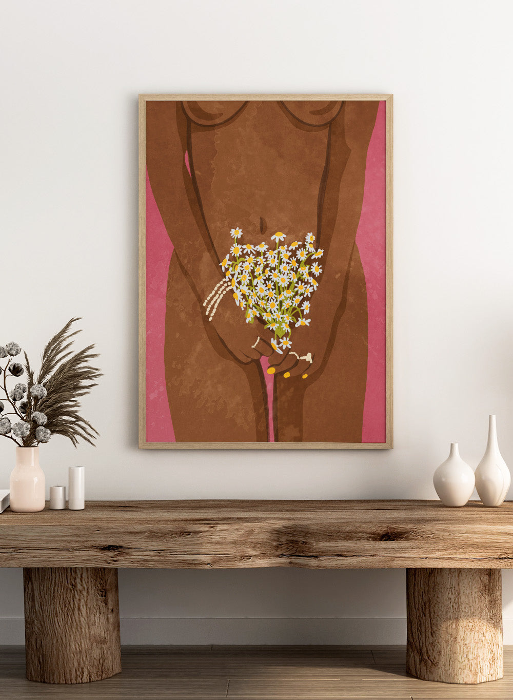Illustration of a hand holding flowers against a brown background. Wearing Flowers by Raissa Oltmanns is a modern woman portrait art print with daisies, pink background, and minimalist graphic wall poster design.