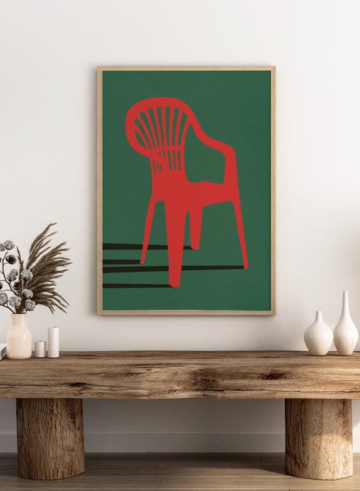 Bold Red Chair by Lisa Solomoniuk premium framed fine art print featuring a vivid red chair, deep green background, and long black shadows.