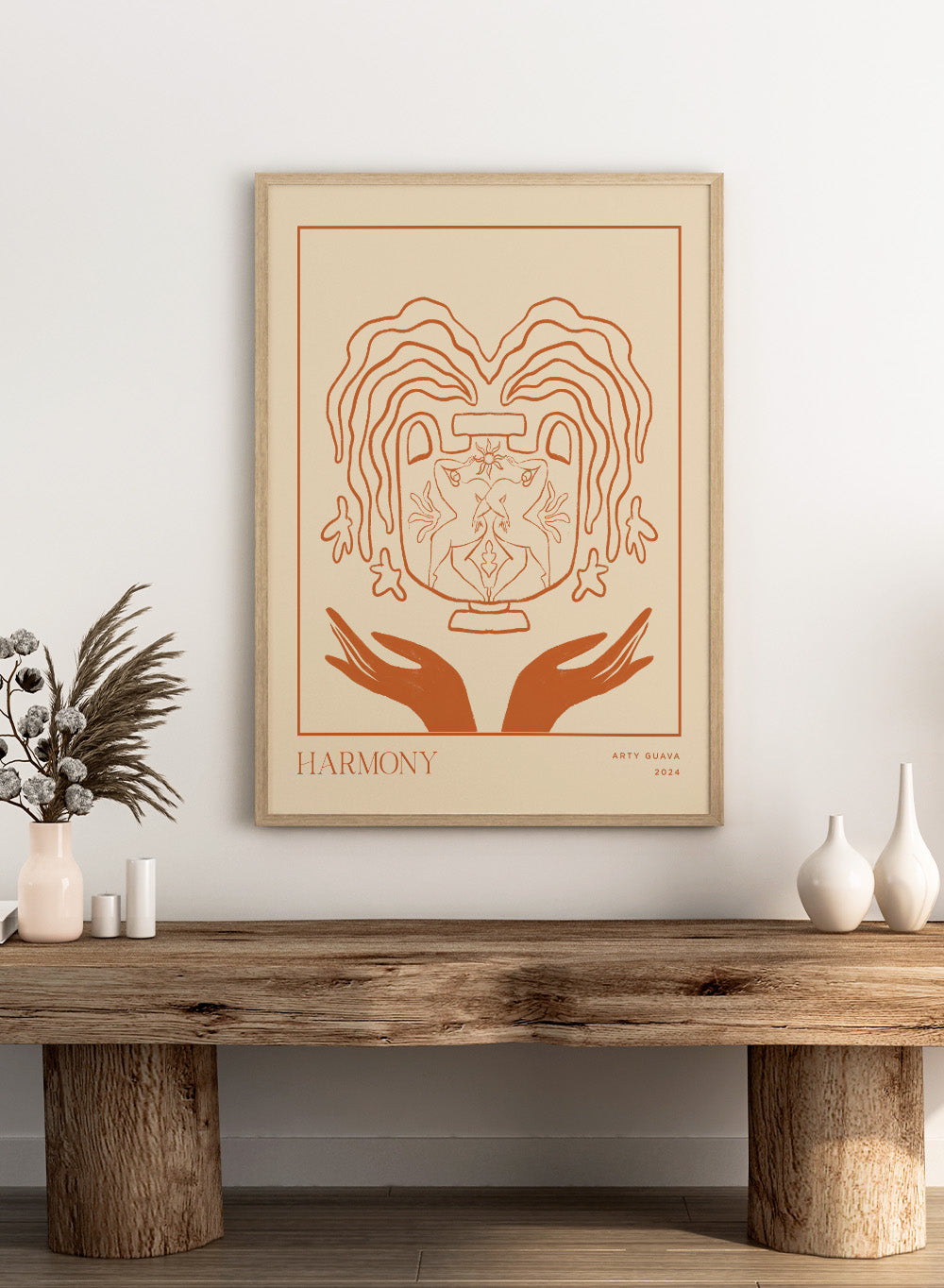 Artistic illustration of a heart with hands holding it, titled 'Harmony' by Arty Guava 2024. Harmony by Arty Guava is a minimalist vessel art print with terracotta linework, mirrored figures, and symbolic calm. Officially licensed wall poster.
