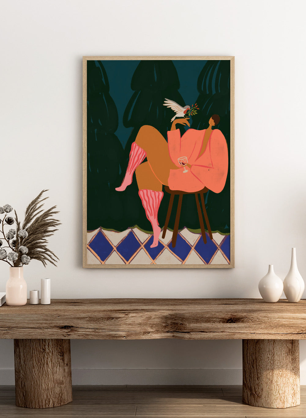 Illustration of a person in a pink dress sitting on a stool with a glass of wine, holding a dove with an olive branch. A Lil Birdy Told Me by Arty Guava is a modern woman art print with a bird, pink robe, and bold color. Officially licensed wall poster.