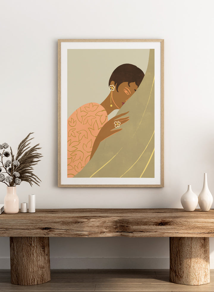 Illustration of a woman wrapped in a floral-patterned shawl with a neutral background. The Introvert by Arty Guava is a modern portrait illustration featuring a woman figure, soft color palette, contemporary wall art style, and officially licensed artwork.