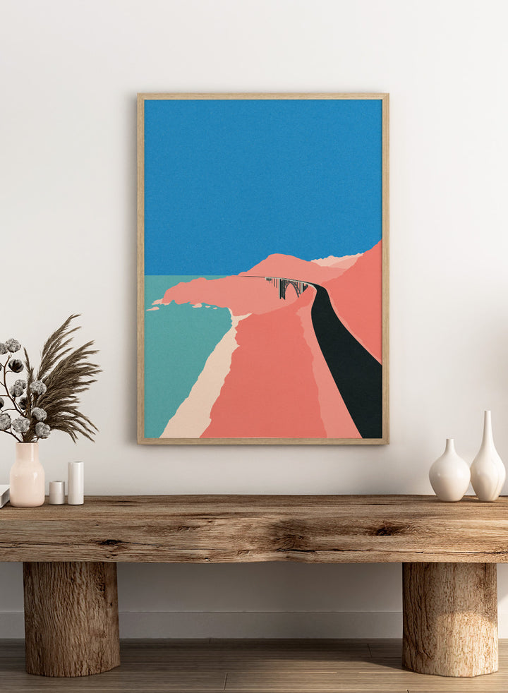Artistic illustration of a coastal road with cliffs and blue sky. Pacific Coast Highway Big Sur by Rosi Feist is a modern minimalist landscape art print with bold color and Bauhaus-inspired graphic design. Officially licensed fine art poster with framing.