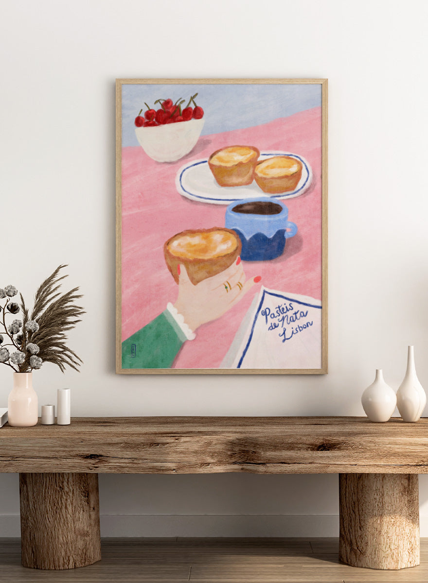 A stylized illustrated scene showing a hand holding a pastry, with two pastries on a plate, a cup of coffee, a bowl of cherries, and a napkin reading &