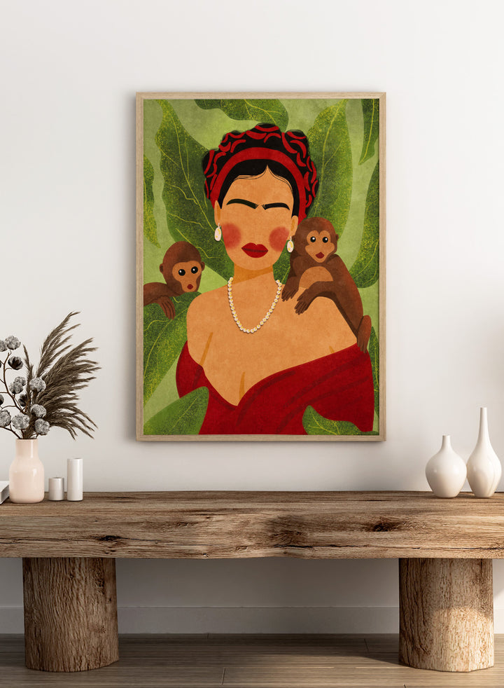 Illustration of a woman with two monkeys on a green leafy background. Frida and Monkeys by Raissa Oltmanns fine art print featuring modern Frida Kahlo portrait with monkeys, bold contemporary wall decor poster.