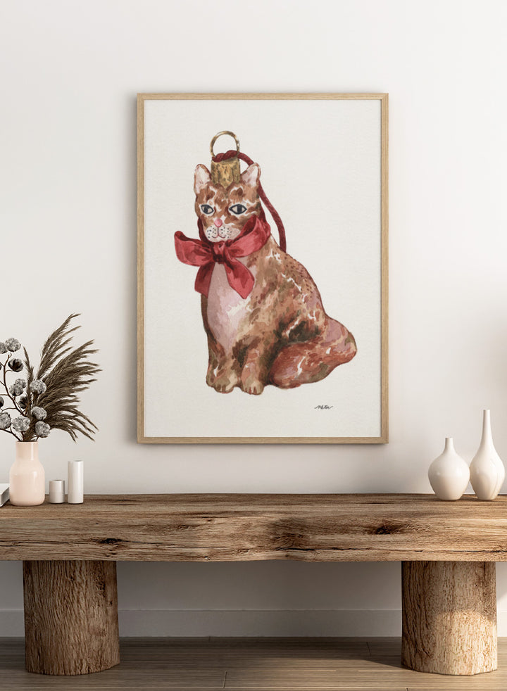 Shop Charming Cat Ornament by NKTN, a festive cat wall art print poster featuring a brown tabby with an oversized red bow and watercolor holiday style.