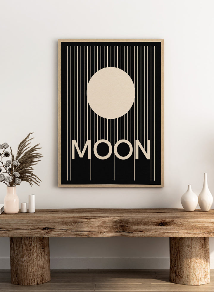 Poster with a stylized moon and the word 'MOON' on a black background. Moon by Rosi Feist is a bold minimalist Bauhaus-inspired art print with a cream circle and graphic lines. Officially licensed modern poster with framing.