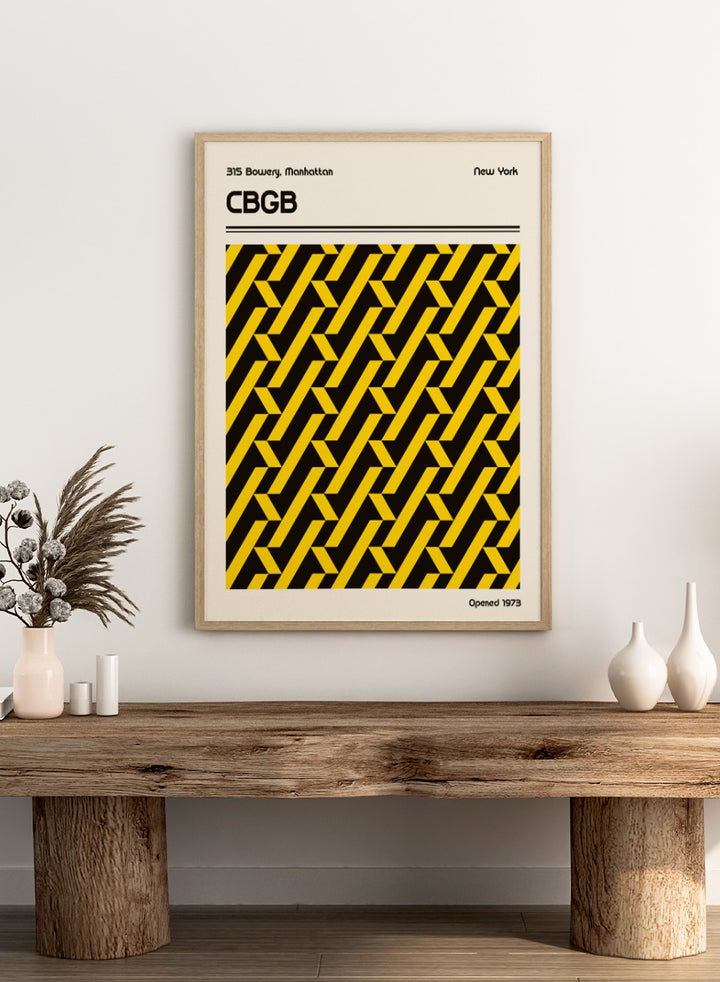 A vintage-style poster or print featuring a bold black and yellow geometric pattern in the center, with the text &