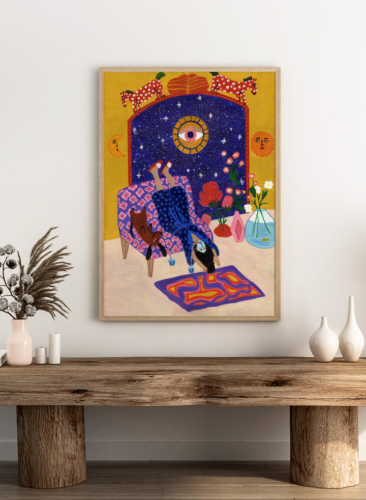 Colorful artwork of a person sitting on a chair with animals and decorative elements. Day Off From Office by Jota de Jai is a whimsical modern art print of a woman upside down with her dog, mid skincare routine, officially licensed wall poster with framing.