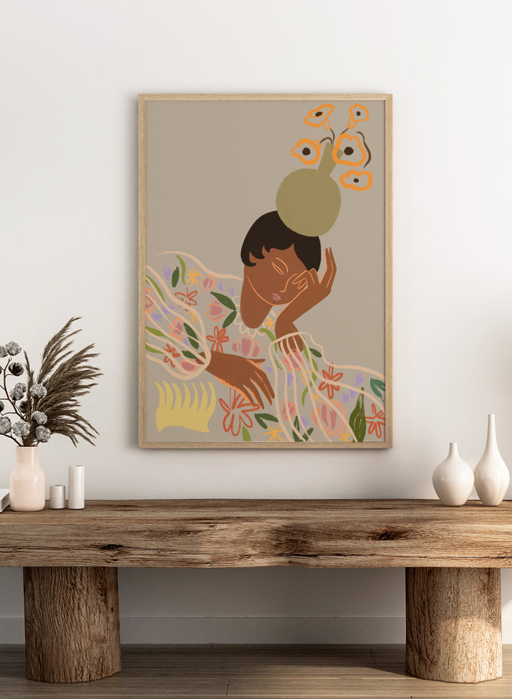 Illustration of a person with a flower on their head against a beige background. The Overthinker by Arty Guava is a modern woman illustration art print with soft florals and warm tones. Officially licensed wall poster with framing.