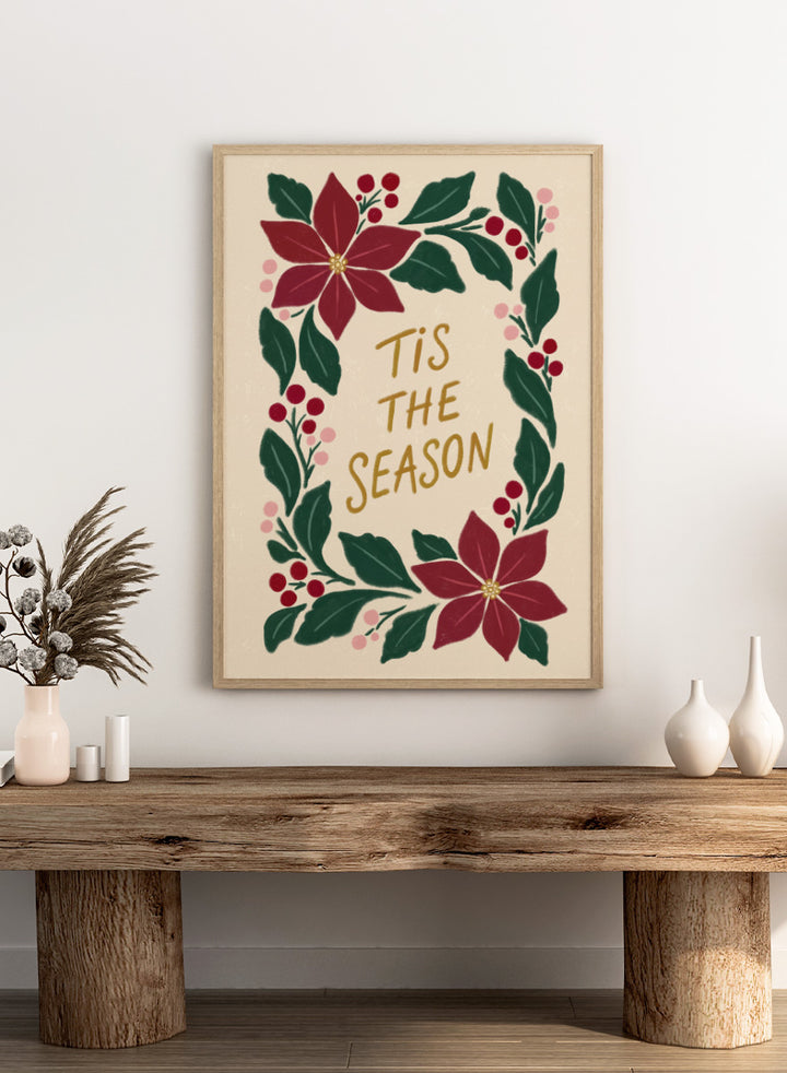 Shop Tis The Season Wreath by Katarzyna Gąsiorowska, a Christmas wall art print poster featuring poinsettias, berries, greenery, and festive holiday lettering.