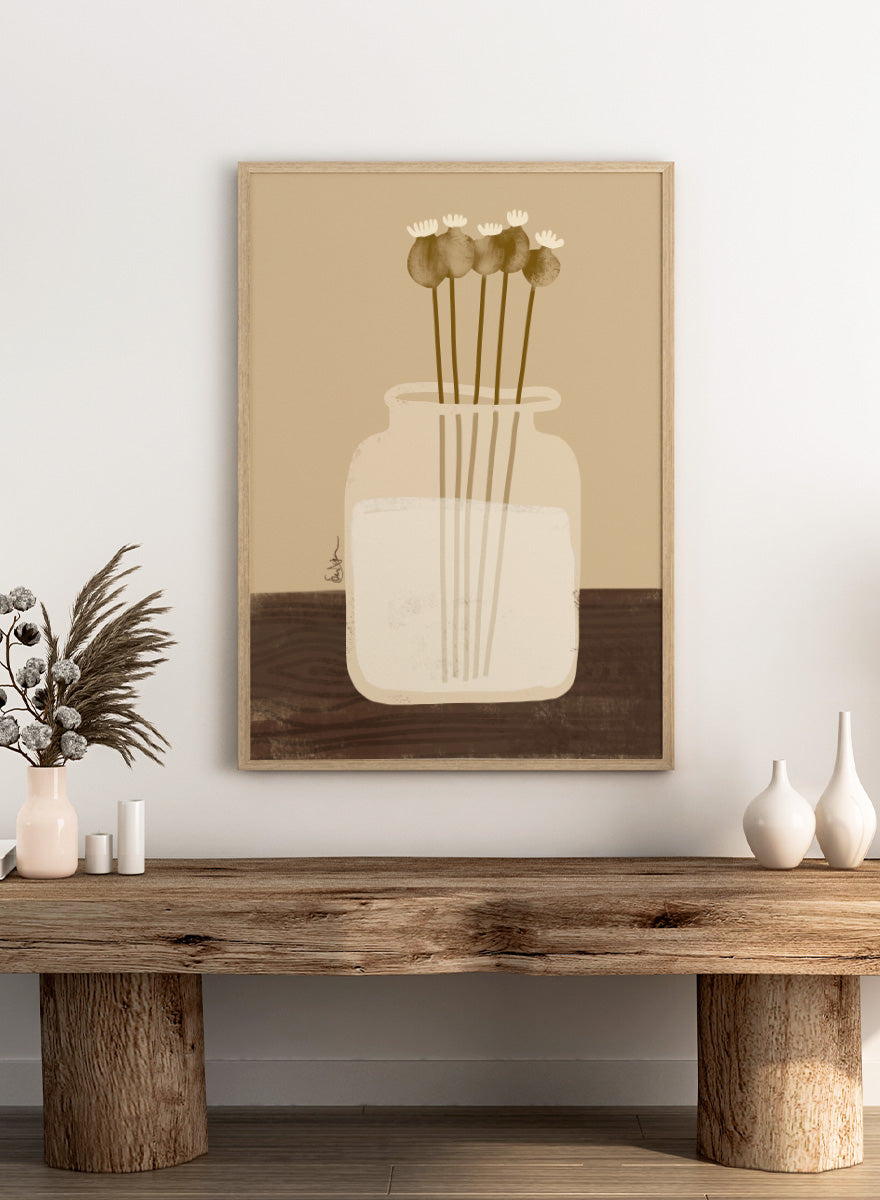 A minimalist art print depicting a clear glass jar filled with white flowers on a dark brown wooden surface against a warm beige background. Shop Rustic Poppy Still Life by Elsa Nätterdal, a botanical still life art print featuring dried poppy pods, a cream vase, and warm earthy tones.