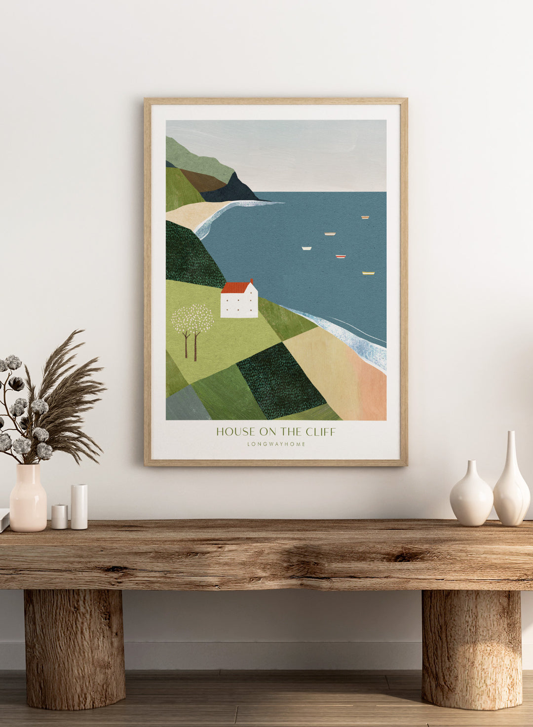 Illustration of a house on a cliff overlooking a coastal scene with boats. House on the Cliff by Longwayhome is a minimalist coastal landscape art print featuring ocean views, cliffside scenery, and modern travel inspired wall art.